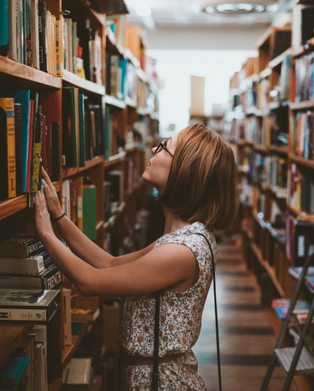 A Woman choosing books on the bookshelf